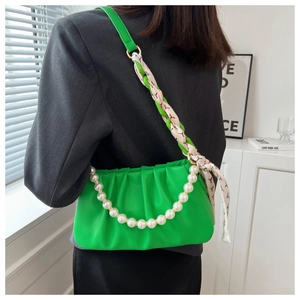 Chic green pleated cloud bag with elegant pearl handle and printed silk scarf detail