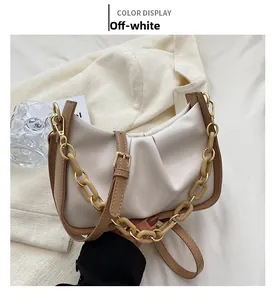 Detail of beige ruched cloud bag featuring acrylic chain and premium PU leather texture