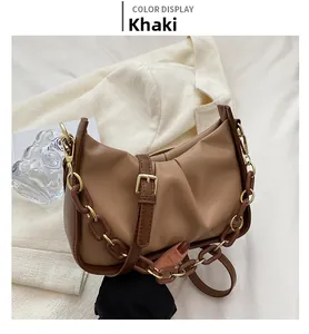 Detail of khaki pleated cloud bag with acrylic chain strap and matte leather finish