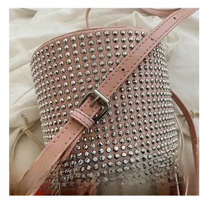 Detail showing pink bucket bag with silver ball rivets and adjustable strap buckle