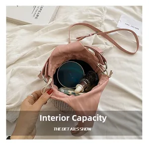 Internal capacity view of pink bucket bag with drawstring and silver metal weave detail