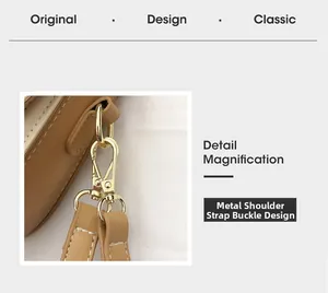 Detail of khaki leather saddle bag showing gold hardware buckle and white stitching craftsmanship