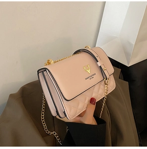 Detail of pink quilted chain bag with gold deer logo and multi-layer side pleats