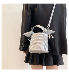 Close-up of stylish rhinestone bucket bag with rabbit ear design and drawstring closure
