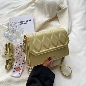 Modern light green embossed square crossbody bag with stylish wave texture and silk scarf