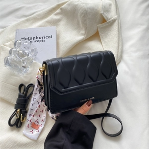 Fashionable black faux leather crossbody bag with leaf quilting and silk scarf detail