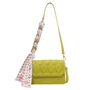 Bright green embossed flap crossbody bag with silk scarf accessory and wave texture