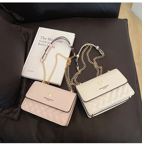 Close-up of quilted leather crossbody bags with golden deer hardware and chain straps