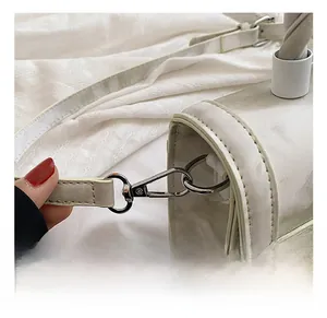 Detail showing the silver alloy strap hook and white PU leather on this small square bag
