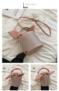 Detailed view of pink cylinder bucket bag with silver studs and rabbit ear drawstrings