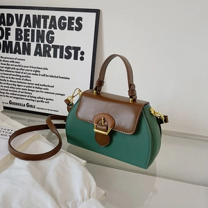 Vintage green and brown leather crossbody bag with top handle and gold hardware detail