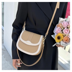 Detail showing vintage saddle bag in beige and cream with adjustable shoulder strap