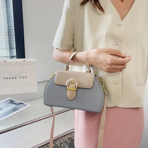 Chic two-tone leather handbag in blue-grey and beige with gold metal buckle detail