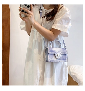 Detail of light purple cloud-textured mini bag featuring a silver flower twist lock closure