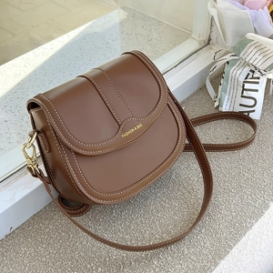 Vintage brown saddle shoulder bag with contrast stitching and golden hardware detail
