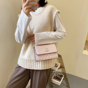 Pink quilted shoulder bag with gold deer head logo and metal chain strap for women