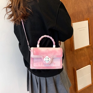 Pink marble pattern crossbody bag with twisted handle and white flower clasp on model