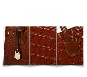 Close-up of brown crocodile texture leather and golden metal rivets on the handbag