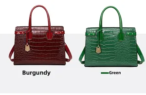 Detail of red and green faux crocodile skin tote bags with glossy finish and top handles