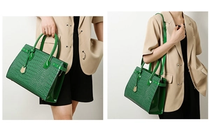 Detail view of a green crocodile embossed handbag with gold hardware and strap