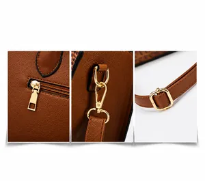Detalle de bolso marrón con textura litchi, cremallera trasera y ganchos dorados