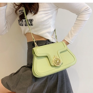 Lime green minimalist crossbody square bag with golden crown lock worn by a model