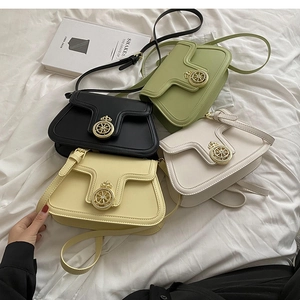 Detail of trendy small square bags in multiple colors with golden decorative metal locks
