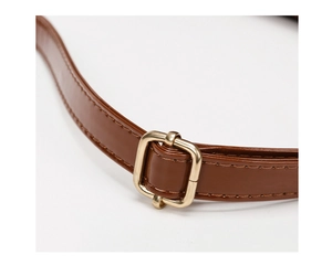 Detail of brown faux leather shoulder strap with golden adjustable metal buckle
