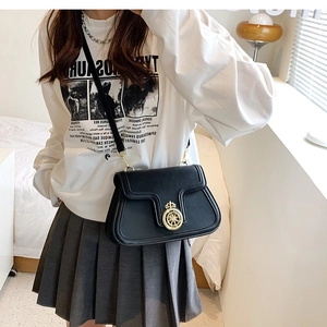 Classic black leather crossbody bag featuring a vintage gold crown emblem and metal buckle