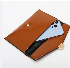 Brown faux leather envelope clutch interior space showing fit for a smartphone