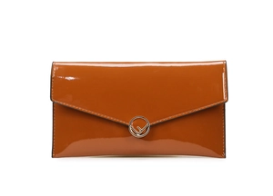 Detailed view of caramel brown patent leather envelope clutch with metallic logo buckle