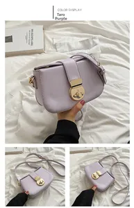 Detail view of taro purple leather crossbody bag with a large gold twist-lock buckle