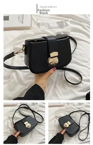 Detail of black crossbody bag featuring a large round gold metal lock and leather texture