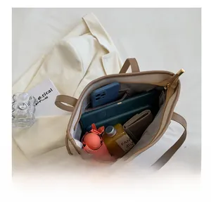 Top view showing the large capacity and multiple compartments of this brown PU tote bag