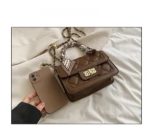 Brown quilted crossbody bag size comparison with smartphone showing practical dimensions