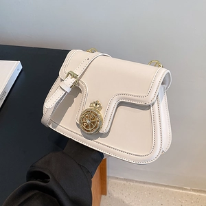 Chic white structured crossbody bag featuring a golden crown buckle and leather strap
