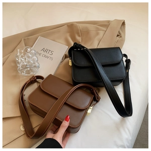 Detail of vintage square flap shoulder bags in black and brown matte leather