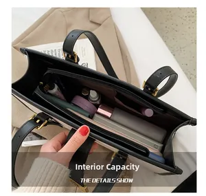 Internal capacity of large tote bag showing spacious compartments for cosmetics and phone