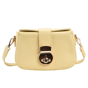 Minimalist light yellow crossbody bag with semicircular flap and gold metal clasp