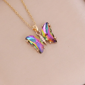 Close-up of butterfly pendant with iridescent gradient wings and golden chain details