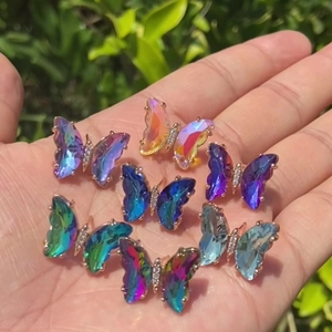 Colorful gradient crystal butterfly earrings with gold plating shown in natural light