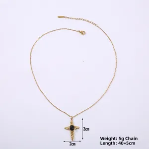 Detail of cross pendant necklace with black natural stone and gold stainless steel chain