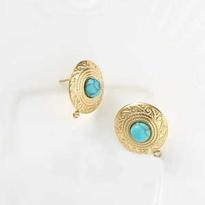 Detail of vintage gold round stud earrings with turquoise stone and delicate wave relief