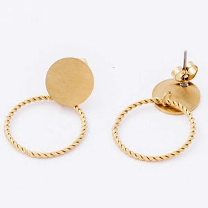 Macro detail of gold-plated twisted hoop earrings with brushed metal studs and secure backs
