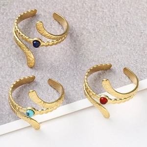 Detailed view of gold snake-shaped adjustable rings with turquoise and natural stones