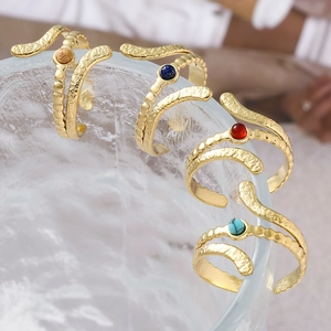 Golden snake-shaped titanium steel ring set with natural stones and hammered texture