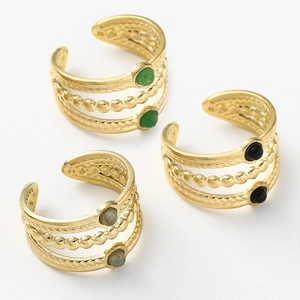 Detailed view of layered titanium steel rings with natural green, black, and grey stones