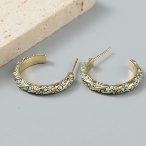 Golden C-shaped twisted earrings featuring two rows of sky blue decorative beads