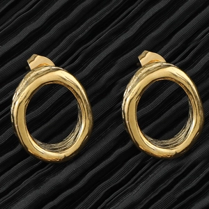 Elegant gold hollow heart earrings with vintage lava texture on black fabric background