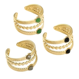 Three-piece gold titanium steel multi-layer rings set with natural stones on white background